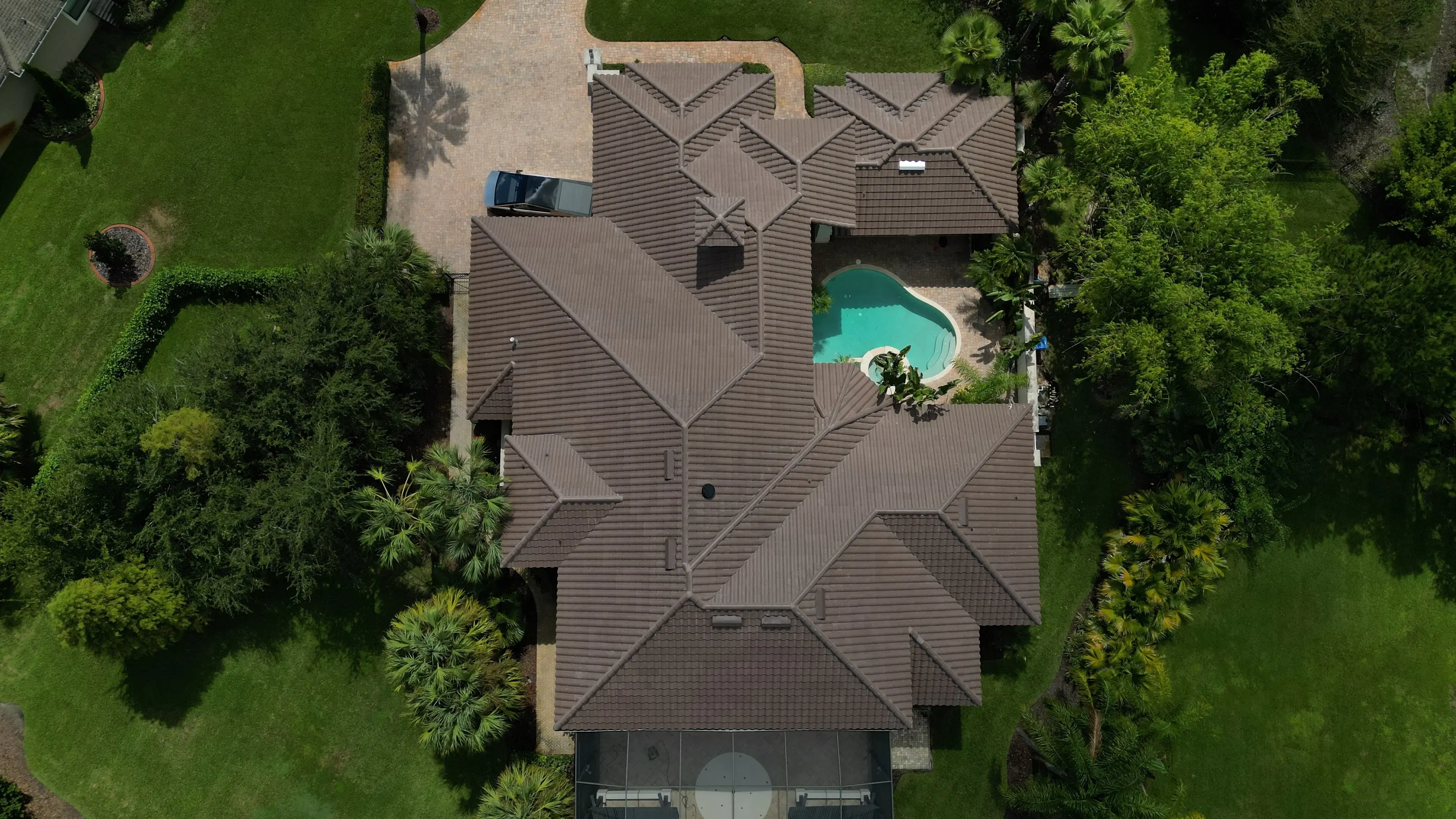 Aerial view of Florida home with professional tile roof and pool — Florida Pro Roofing residential roofing project in New Port Richey